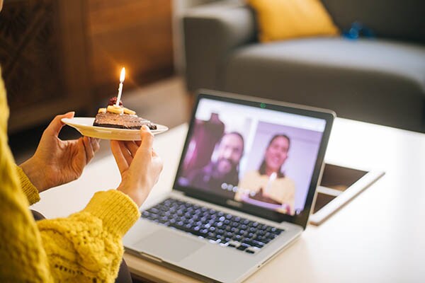 Woman celebrating birthday with video conference